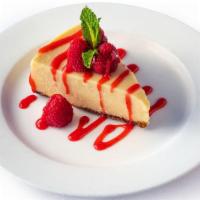 Cheesecake · Creamy cheesecake with a graham cracker crust finished with raspberry sauce and mint.