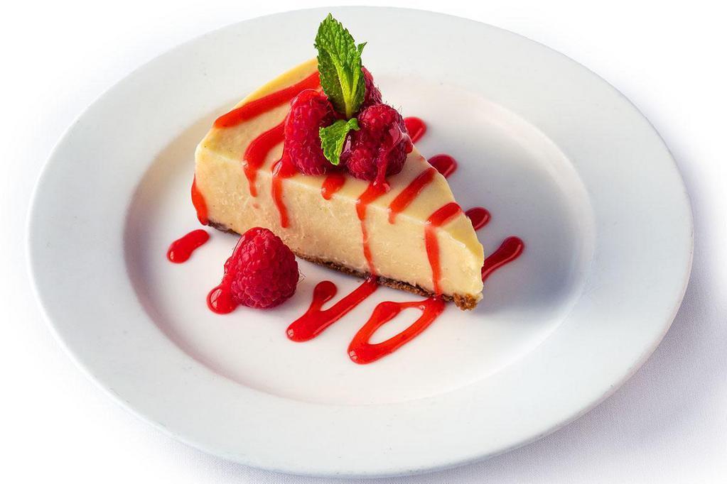 Cheesecake · Creamy cheesecake with a graham cracker crust finished with raspberry sauce and mint.