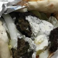 Falafel Pita · Three falafel patties rolled in pita bread with tomatoes, lettuce, onions and our homemade t...