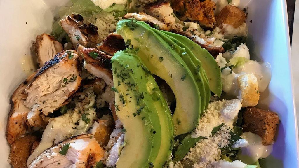 Avocado Grilled Chicken Caesar Salad · Grilled chicken served over Romaine lettuce tossed with Parmesan Caesar dressing, croutons, and topped with avocado.