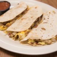 Breakfast Tacos · Three flour tortillas filled with eggs, potatoes, onions and choice of bacon, sausage, ham, ...