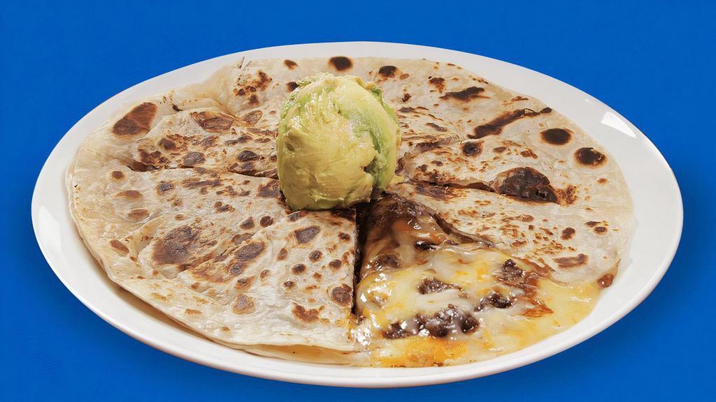 Quesa Super Beef Fajita · If you have a large appetite, then try our Super Quesadilla. Two nine inch ﬂour tortillas stuﬀed with Muenster cheese and your choice of Meat, topped with fresh guacamole. Includes a side of our famous refried beans and cool sour cream. Pictured with Beef Fajita.