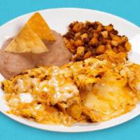 Chilaquiles Plate · Spice up your morning with our Chilaquiles breakfast plate. Comes with crispy corn tortilla ...