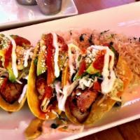 Blackened Mahi Mahi Tacos (2) · 2 tacos w/ Cajun spiced mahi filets, cilantro slaw, lime crema, salsa roja and cotija cheese...