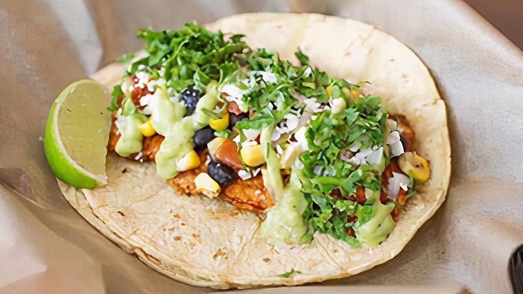 Orange · Blackened salmon topped with a grilled corn and black bean relish, cotija cheese and cilantro. Drizzled with avocado sauce, then served with a wedge of lime on a corn tortilla. Dairy, Soy, Avocado, Gluten, Fish.