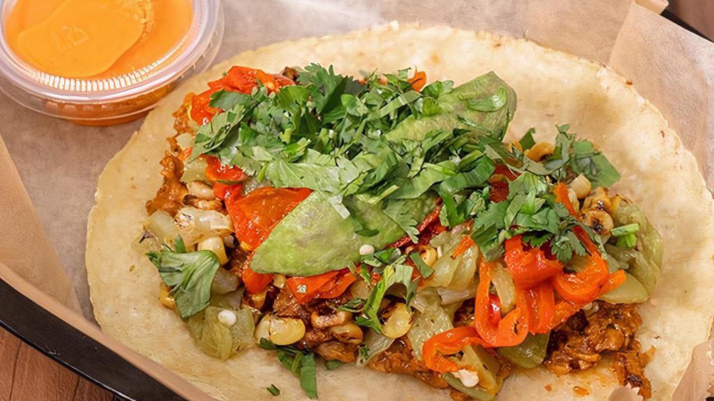 The Mofaux · Plant-based and Damn Good! Cowboy-style Beyond Beef, green chiles, grilled corn, peppadew peppers, avocado & fresh cilantro with Diablo sauce on a corn tortilla. *Soy