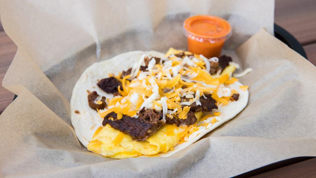 Ranch Hand · Tender strips of grilled beef fajita with scrambled eggs & shredded cheese.  Served with DIABLO SAUCE on a flour tortilla. Dairy, Soy, Eggs, Gluten. *Flour tortillas contain Gluten. *Scrambled eggs contain Dairy