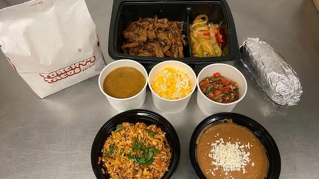 Family Pack Beef Fajita · Family packs serve 4-5 people! Marinated & Grilled Beef, Grilled Onions & Peppers, Pico de Gallo, Cheddar Jack Cheese & Roja Sauce. Includes Homemade Chips, Beans, Rice & your choice of Tortillas (Flour, Corn, Combo).