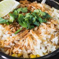 Street Corn · Fresh roasted off-the-cob corn topped with ancho aioli, cotija cheese, cilantro, and dusted ...