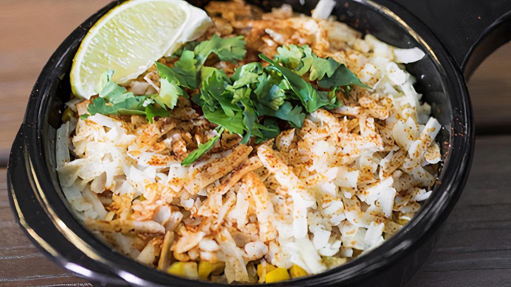 Street Corn · Fresh roasted off-the-cob corn topped with ancho aioli, cotija cheese, cilantro, and dusted with New Mexico red chili powder. Dairy, Soy, Eggs