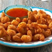New! Coconut Shrimp · Poppable golden shrimp coated in a crispy coconut breading served with a sweet, spicy and ta...