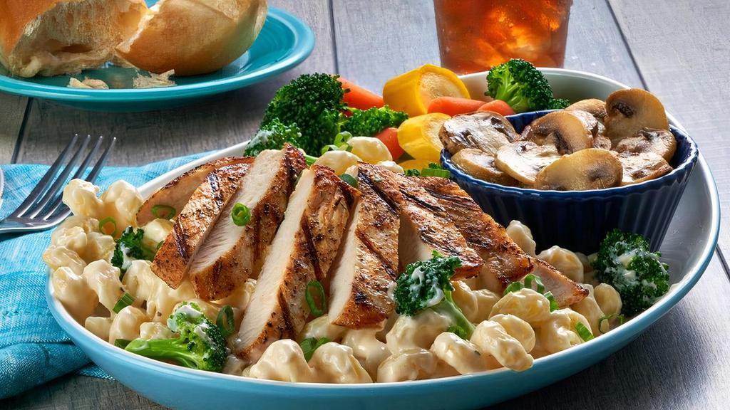 Chicken Alfredo Pasta · Creamy alfredo sauce tossed with cavatappi pasta, steamed broccoli, green onions and parmesan cheese.