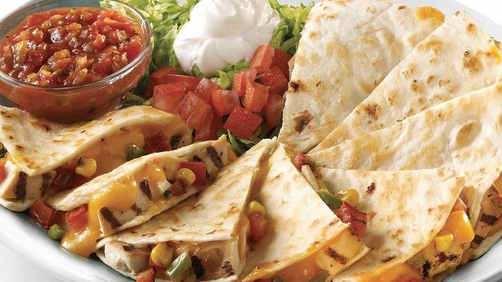 Chicken Quesadilla · Grilled chicken, monterey jack and cheddar cheeses, and corn salsa, all packed in a flour tortilla and grilled to melty perfection, served with sour cream and freshly made salsa