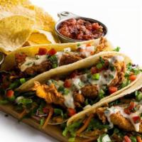 Grilled Chicken Street Tacos · Three warm tortillas filled with fresh pico de gallo, homemade slaw, and zesty chipotle sauc...