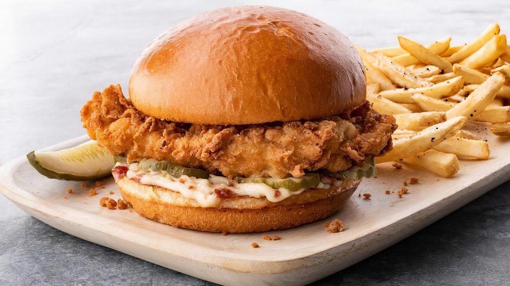 Chicken Fried Chicken Sandwich · Hand breaded, crispy golden fried chicken breast, with bacon-mayo and pickles on a toasted butter bun. Served with fries