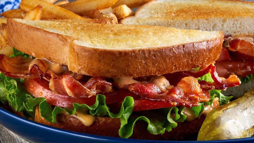 The Blt · Piled high with crispy strips of bacon, fresh lettuce, ripe tomatoes, and mayo on our homestyle white toast. Served with fries