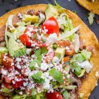 Mexican Tostadas · Comes with choice of meat, beans, lettuce, tomato, and Mexican queso fresco.