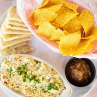 Artichoke And Goat Cheese Dip · Oven-Baked Artichoke, Green Chile, and Goat Cheese Dip served with Pita Bread and Tortilla C...
