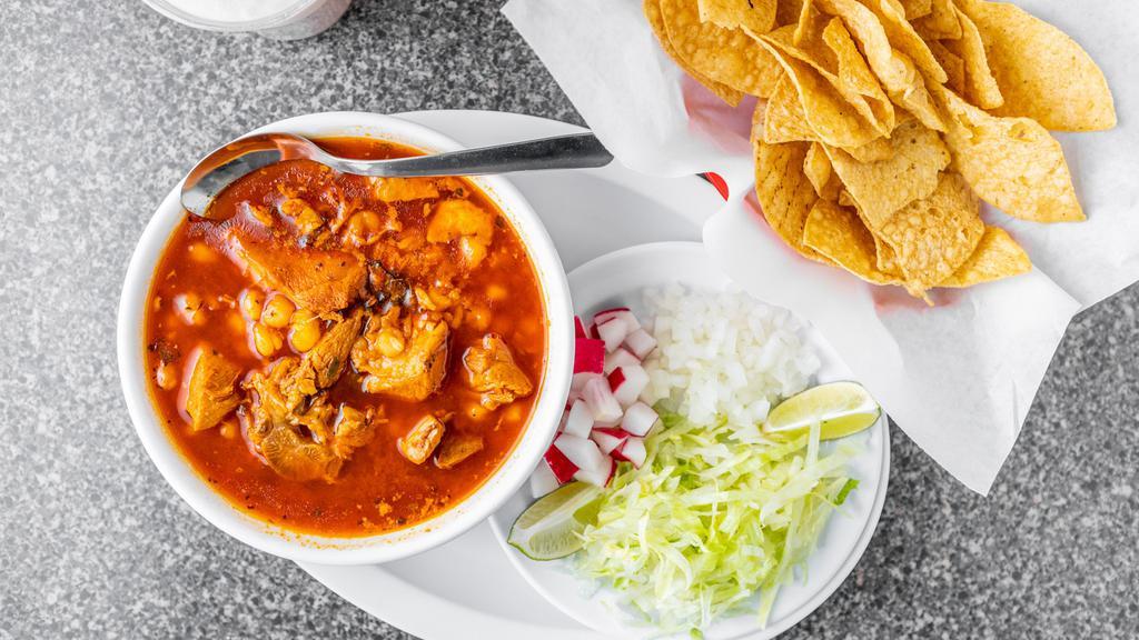Pozole · Savory pork, hominy, and red chilis plus the added extras of shredded lettuce, diced onion, and diced radish.