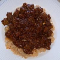 Beef And Rice · Mildly spiced sautéed beef and chopped red onions and jalapeno served over a bed of slow coo...