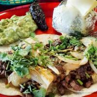Steak Tacos · 4 steak tacos with guacamole and chile toreado.
