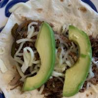 Brisket Taco · Slow roasted brisket, grilled polano peppers, roasted onions, cheese, avocado, flour tortilla