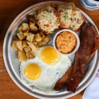 Farmer'S Breakfast · sunny side up local eggs, millionaire's candied bacon, herb potatoes, bacon & jalapeño biscu...