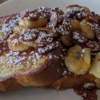 Hills French Toast · Our french toast topped with carmel nuts and bananas whipped cream and powdered sugar.
