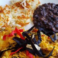 Migas · Scrambled eggs, tortilla strips, jalapeños, tomatoes and onions, topped with aged cheddar. S...
