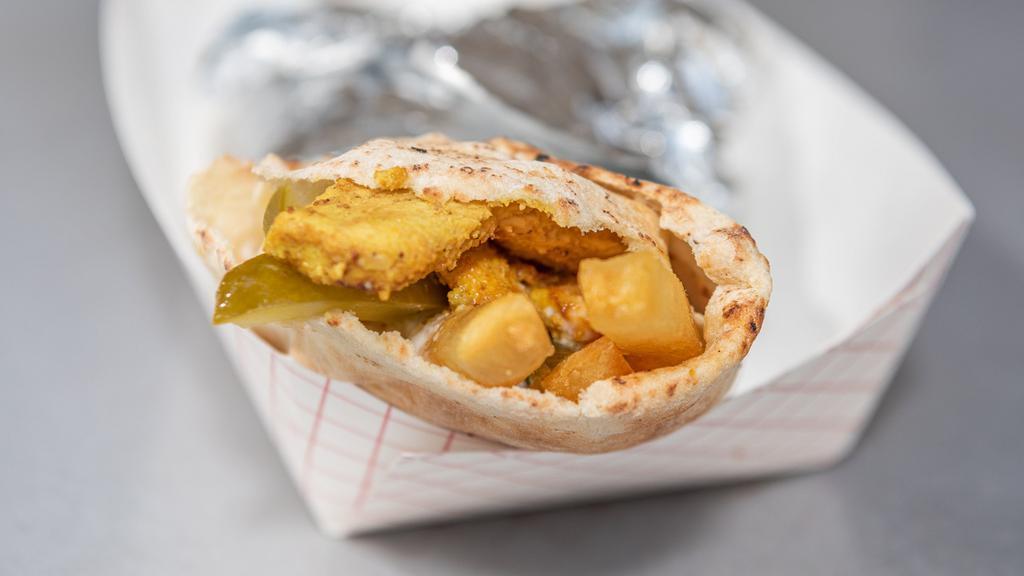 Shish Tawook Wrap · Marinated chicken, French fries, tomato, pickles, and garlic aioli.