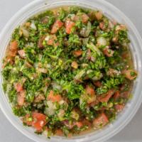 Taboulleh Salad · Vegan. Parsley, mint, tomato, onion, crushed wheat, lemon juice, and olive oil.
