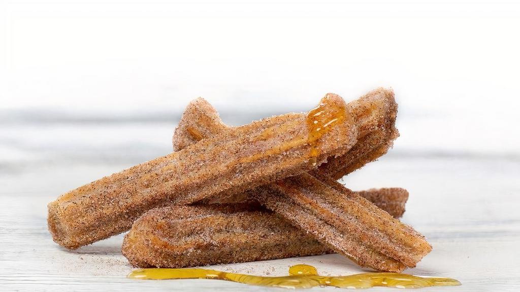 Churros · strips of fried dough filled with cajeta, dusted with sugar and cinnamon