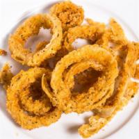 Onion Rings · Fresh breaded onion rings fried golden brown served with ranch for dipping.