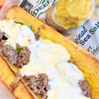 --Philly Sammich · Shaved ribeye with grilled jalapenos and onions. Topped with house queso and served on a hoa...