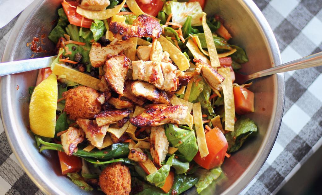 Chicken Salad · Mixed greens topped with shredded carrots, roma tomatoes, cubed avocado, sliced cucumber, dried cranberries, sliced almonds, and two hushpuppies.  Topped with grilled chicken breast.
