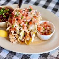 Grilled Tilapia Tacos · Three crispy corn tortillas stuffed with grilled tilapia, pico de gallo, coleslaw, and comeb...