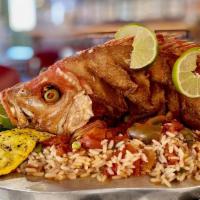 Snapper Veracruz · Fried whole red snapper served with rice and vegetables, topped with veracruz sauce.