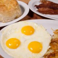 Three Egg Special · Golden hash browns or grits, toast or biscuit with country cream gravy.