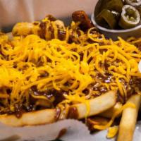 Chili Cheese Fries · Golden fries topped with Cheddar cheese and delicious homemade chili.