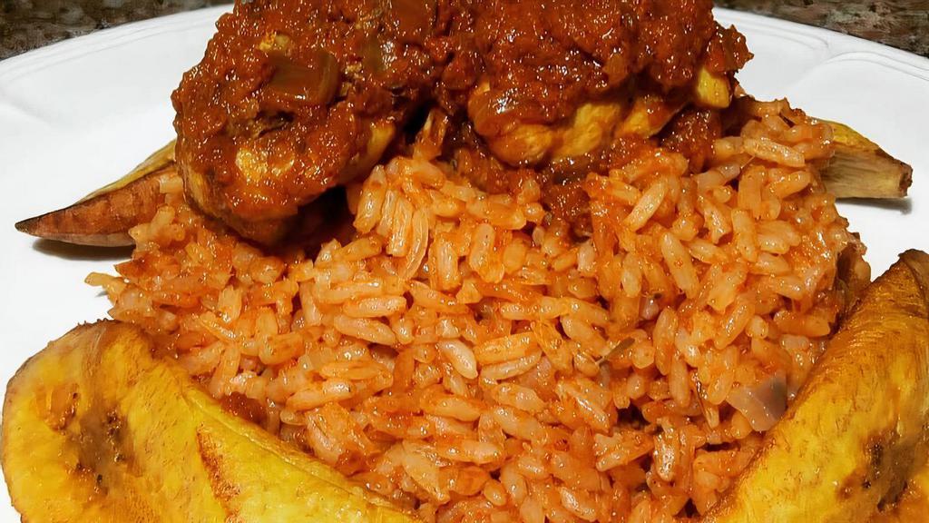 Jollof Rice W Chicken And Fried Plantains · A West African mainstay, also called Benachin is a flavorful tasty rice, simmered in spicy savory deep fried tomato stew. It is served with fried plantain and chicken.