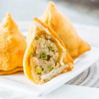 Vegetable Samosa · Crispy pastries stuffed with potatoes and peas, lightly seasoned with spices.