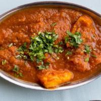 Fish Curry · Fish cooked with delicately spiced curry sauce.