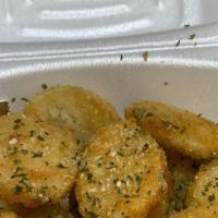 Fried Pickles · Dill sliced pickles breaded and fried. Garnished with Italian herbs and served with your cho...