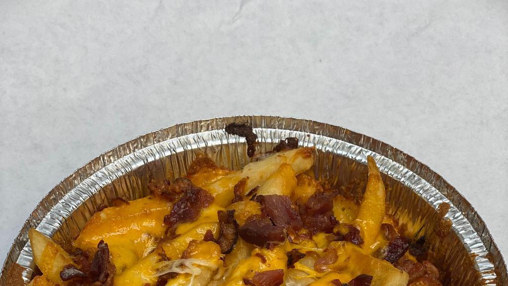 Cheddar Bacon Fries · Crisp thick French fries topped with fresh shredded Cheddar cheese and real bacon crumbles piled into a 7