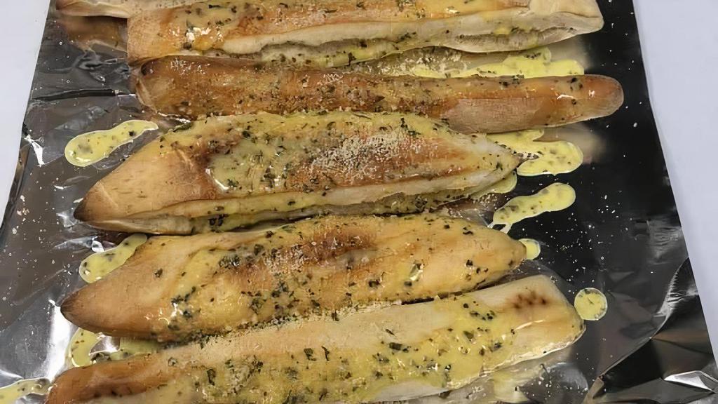 Classic Bread Sticks · Rolled from fresh pizza dough and topped with imported Italian Parmesan, fresh Italian herbs and drizzled with our garlic butter sauce. Served with sides of our housemade pizza sauce!.