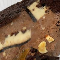 Chocolate Eruption Cake · A large slice of dense chocolate cake rich with triple chocolate flavor with huge chunks of ...