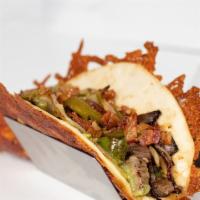 Austin Cheesesteak Taco · Crispy cheddar flour tortilla, avocado salsa, fajita steak, pickled jalapeños, bell peppers,...