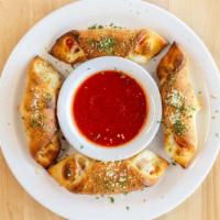 4 Pizza Rolls · Pizza dough formed into a pocket and filled with sauce and cheese.