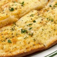 Garlic Bread · Grilled artisan baguettes topped with our housemade buttered garlic spread and Italian spices.