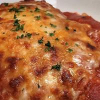 Chicken Parmesan (Hand Breaded Per Order) · Breaded chicken breast baked in our housemade marinara and mozzarella - served with spaghetti.